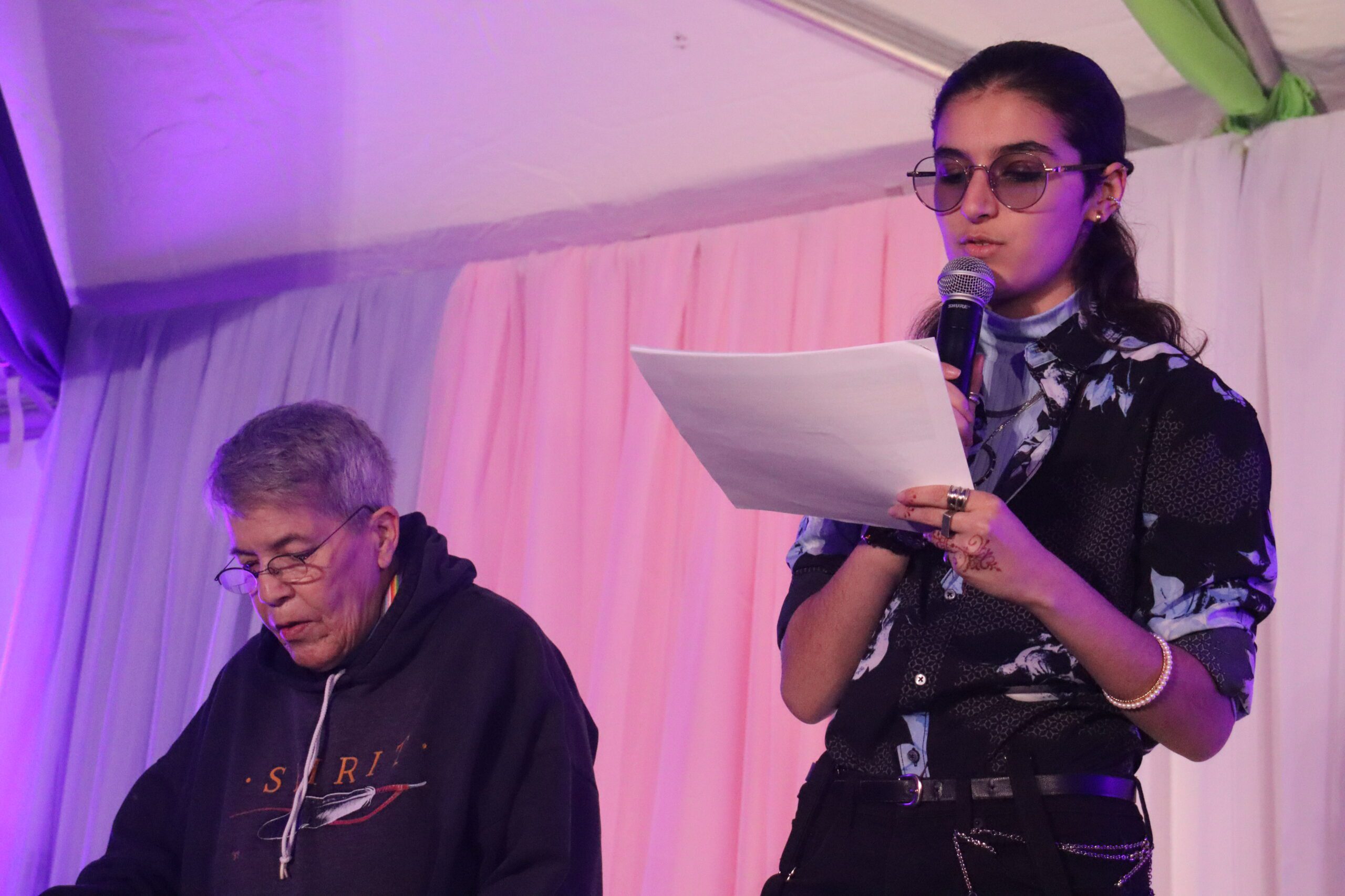 Jayan hosting the Trans Day of Remembrance event with Nicole