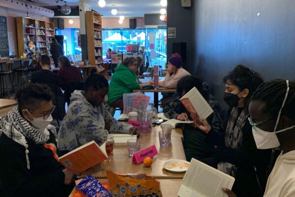 Participants in the first cohort of the 2SQTBIPOC Book Club, reading together at Glad Day.