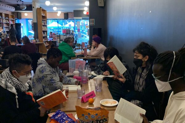 Participants in the first cohort of the 2SQTBIPOC Book Club, reading together at Glad Day.